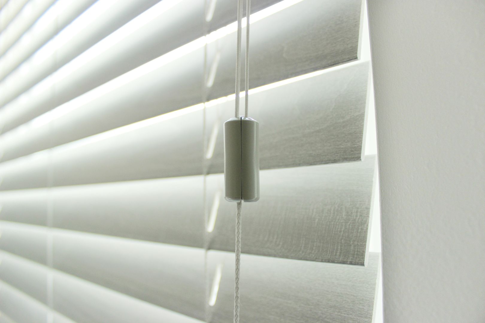 Comfortex Aria Faux Wood Blinds hanging